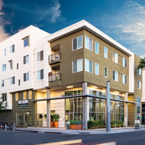 Apartments in San Jose CA - Beautiful Apartment Building with a Modern Exterior Showcasing Large Community at Dusk